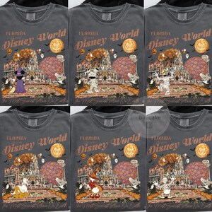 Op de afbeelding: Donkergrijze t-shirts met een Halloween-thema Disney World-afbeelding. Het ontwerp bevat pompoenen, vleermuizen en stripfiguren. De tekst luidt "Florida Disney World" en "The Most Scariest Place On Earth."