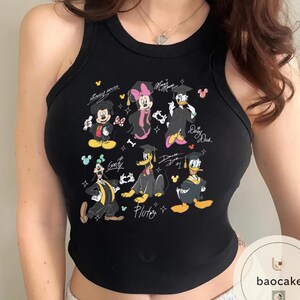 May include: Black tank top featuring a colorful graphic of Disney characters in graduation attire. Mickey Mouse, Minnie Mouse, Donald Duck, Daisy Duck, Goofy, and Pluto are depicted with graduation caps and gowns. The words "Mickey Mouse", "Minnie Mouse", "Daisy Duck", and "Goofy" are written on the top.