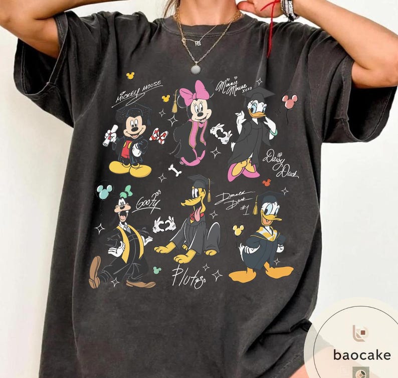May include: Dark gray t-shirt featuring cartoon characters Mickey Mouse, Minnie Mouse, Donald Duck, Daisy Duck, Goofy, and Pluto in graduation attire. The shirt includes the text "Mickey Mouse", "Minnie Mouse", "Daisy Duck", and "Pluto".