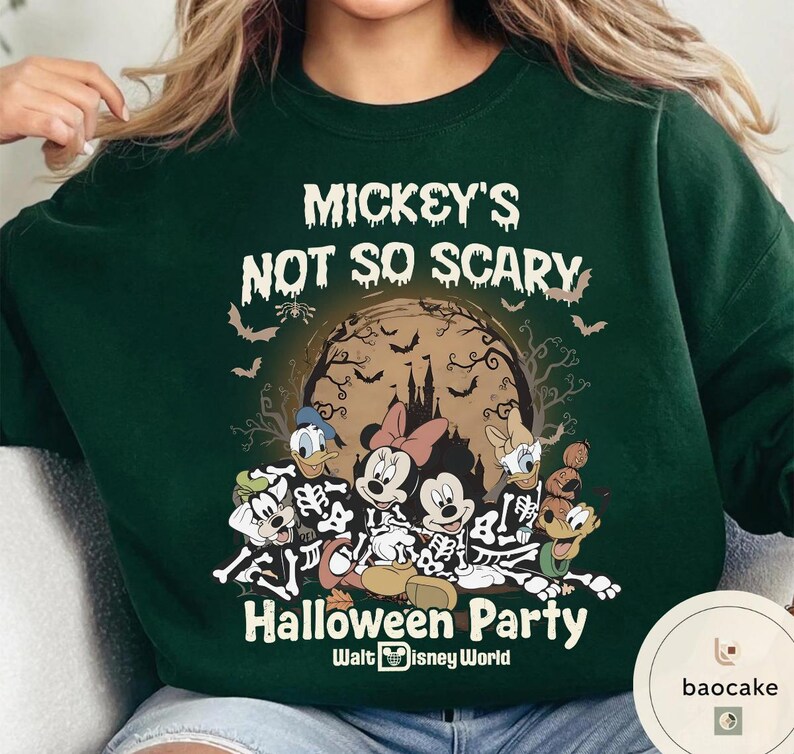 May include: Dark green sweatshirt featuring a Halloween-themed graphic. The design includes Mickey Mouse, Minnie Mouse, Donald Duck, Daisy Duck, and Goofy dressed as skeletons. The text "Mickey's Not So Scary Halloween Party" is printed above the characters.
