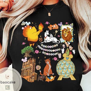 May include: Black t-shirt featuring a colorful graphic of various Disney characters, including Simba, Dumbo, and Dalmatian dogs. The phrase "Happiest Dad on Earth" is also displayed. The shirt has a crew neck and short sleeves.