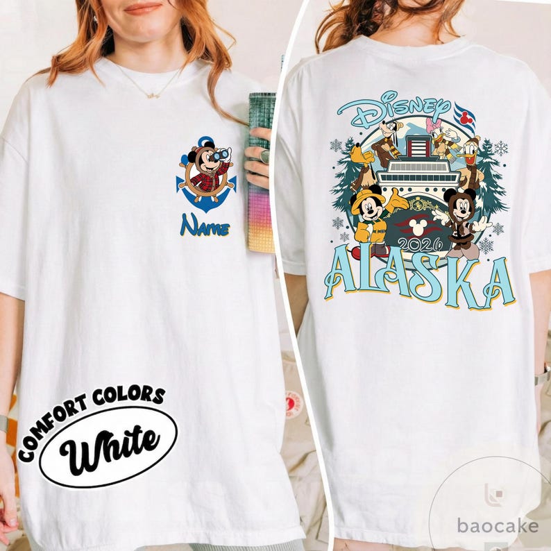 May include: White t-shirt with Disney graphics. The front features Mickey Mouse in a nautical anchor design with the word "Name". The back displays a Disney Alaska design with Mickey, Donald, and Goofy. The shirt also has the words "Comfort Colors White".
