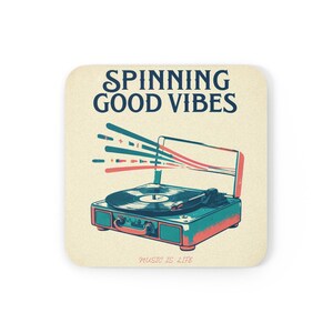 May include: Square coaster featuring a retro illustration of a teal and coral record player. The text "SPINNING GOOD VIBES" is above the record player, and "MUSIC IS LIFE" is below.