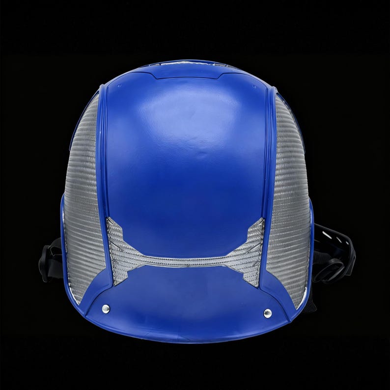 May include: A blue and silver helmet with a futuristic design. The helmet has a smooth, glossy blue top and silver mesh side panels. A black strap is visible on the side. The helmet is set against a black background.