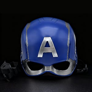 May include: A blue Captain America helmet featuring a large silver "A" on the front. The helmet has silver detailing and eye openings. Black straps are attached. The background is black.