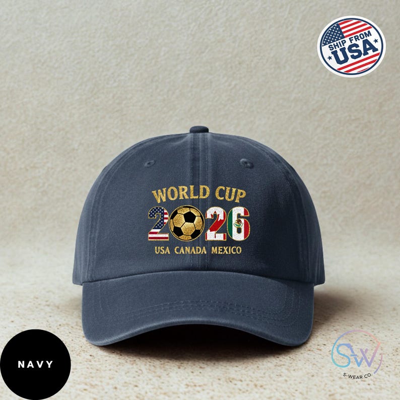 May include: Navy blue baseball cap with gold text reading "WORLD CUP 2026", featuring a soccer ball graphic. The number "2026" incorporates the USA and Mexican flags. The text "USA CANADA MEXICO" is below. A "Ship from USA" sticker is visible.