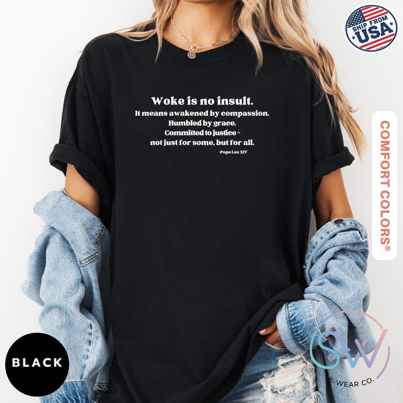 May include: Black t-shirt with the text "Woke is no insult." The text continues with a quote by Pope Leo XIV. The shirt is made by Comfort Colors and has a "Ship from USA" logo.