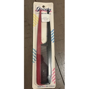 May include: A package of two Goody combs. One comb is red, the other is black. The package has the Goody logo and the text "2 Unbreakable". The package also has the text "Drug Emporium 5.40" and "Made in the USA #125/2".