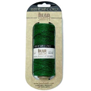 May include: A spool of dark green hemp cord from The Bead Smith, packaged in a cardboard backing. The label reads "100% Hemp Cord" and "Natural Product of the Earth." The spool contains 2 lbs of cord, or 60m/197ft.
