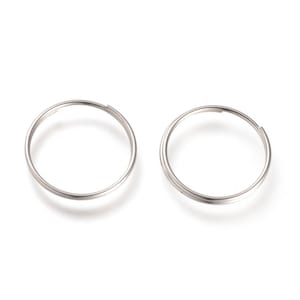 May include: A pair of silver hoop earrings. The earrings are simple and classic, and they would be a great addition to any jewelry collection.