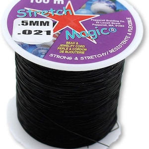 May include: A spool of 100 metres of black stretch magic bead and jewellery cord. The cord is 0.5mm thick and is strong and stretchy. The label reads "Stretch Magic" and "Strong & Stretchy/Resistente & Flexible".