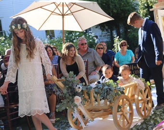baby flower girl in wagon