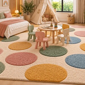 May include: A large rectangular area rug featuring a cream-colored base with a repeating pattern of large, textured circular shapes in muted shades of sage green, dusty rose, mustard yellow, and slate blue, covering the entire floor space.
