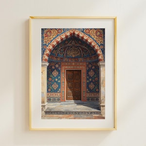 May include: Framed print of an ornate doorway with a wooden door. The archway is decorated with intricate patterns in blue, red, and gold. The print is in a gold frame.