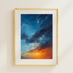 May include: An oil painting of a dramatic sky, framed in a light wood frame. The artwork features a vibrant gradient of colors, with deep blues and dark grays at the top, transitioning to fiery oranges and yellows at the bottom.