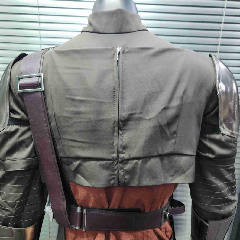 Pu&ograve; includere: Vista posteriore di un costume marrone con una cerniera sul retro. Il costume ha spalline marroni e spalline argentate.