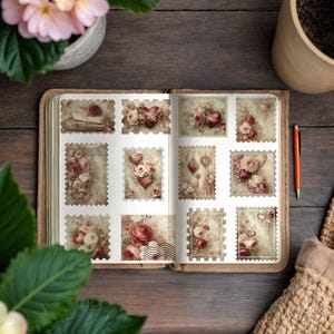 May include: An open journal displays a collection of decorative stamps with a vintage aesthetic. Each stamp features floral and heart designs in shades of pink, red, and cream. The stamps are arranged on a cream-colored page with a scalloped edge.