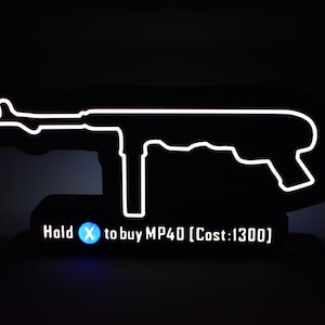 May include: A neon sign depicting an MP40 submachine gun, with a white outline on a black backdrop. The text "Hold X to buy MP40 [Cost:1300]" is below the gun. The sign is mounted on a black stand.