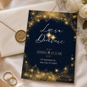 May include: A navy blue wedding invitation with gold glitter accents and the names "Lucia Dominic" in elegant script. The invitation includes the date, time, and address. A gold wax seal, rings, and envelope are also visible.