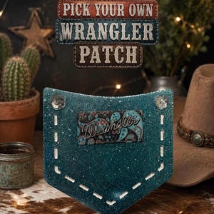 May include: A teal glittery patch with a paisley Wrangler logo. The patch is shaped like a pocket and has white stitching. Above the patch are three rectangular signs that read "PICK YOUR OWN WRANGLER PATCH". A cowboy hat is in the background.