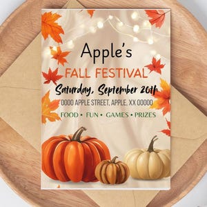 May include: An autumnal invitation for Apple's Fall Festival, with pumpkins and leaves. The text reads "Apple's Fall Festival Saturday, September 20th" with address and event details. The invitation is on a wooden plate with an envelope.