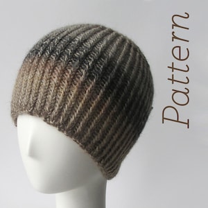 May include: A brown and gray knit beanie with a ribbed pattern. The beanie is on a white mannequin head.