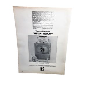 May include: Vintage advertisement for "Instant Replay" on a white background. The ad features a black and white image of a television with a football graphic on the screen. Text includes the phrase "They're talking about 'Instant Replay'" and the names "Pachett & Sapses".