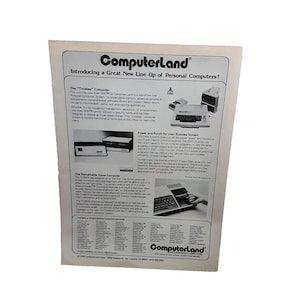 May include: A black and white advertisement for ComputerLand, a computer retailer, featuring a line-up of personal computers. The ad includes images of the Atari 800TM, the TI 99/4A, and the DEC PDP 11/03. The text highlights the features of each computer, including its speed, memory, and software capabilities.
