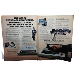 May include: A magazine advertisement for Atari personal computers. The ad features a photo of the Atari 800 computer with a keyboard and a screen. The text in the ad reads "The Atari Personal Computers. You should know why so many people are buying them."