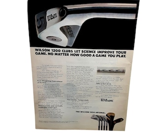 May include: An advertisement for Wilson 1200 golf clubs. The image features a close-up of a golf club head with the Wilson logo. The text reads, "Wilson 1200 Clubs Let Science Improve Your Game."