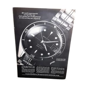 May include: Black and white advertisement for an Accutron Deep Sea watch. The watch has a black face with white markers and hands, and a stainless steel band. Text on the ad reads "All watch movements except this one start going out of adjustment as soon as they are adjusted."