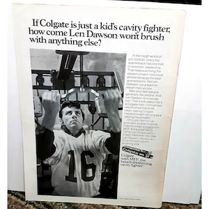 May include: A black and white photo of a football player, Len Dawson, doing a pull-up exercise. The photo is an advertisement for Colgate toothpaste with MFP, the breath-freshening cavity fighter.