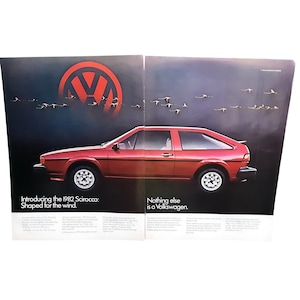 May include: An advertisement for the 1982 Volkswagen Scirocco. The car is a reddish-orange color with a hatchback design. The ad features the Volkswagen logo and the text "Introducing the 1982 Scirocco: Shaped for the wind." and "Nothing else is a Volkswagen."