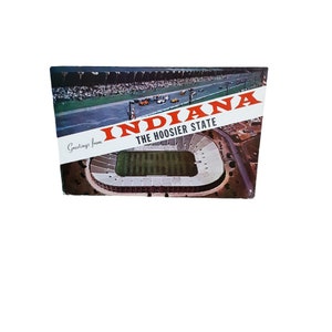 May include: A vintage postcard featuring an aerial view of a large stadium with a green field and the text "Greetings from Indiana The Hoosier State".