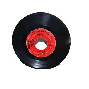 May include: A black vinyl record with a red label. The label says "Columbia" and features the song "Over You" by Gary Puckett and the Union Gap. The record number is 4-44644.
