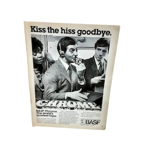 May include: A black and white advertisement for BASF Chrome audio cassette tapes. The ad features a man wearing headphones listening to music and the text "Kiss the hiss goodbye." and "BASF Chrome. The world's quietest tape."