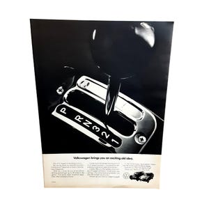 May include: A black and white vintage advertisement featuring a close-up of a car gear shifter with the letters P, R, N, 3, 2, 1 visible. The text reads Volkswagen brings you an exciting old idea, along with descriptive paragraphs and two small car illustrations.