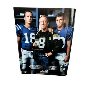 May include: An advertisement featuring three men, two in blue football jerseys with the number 18 and 17, and one in a black jacket. The text "The perfect pass" is visible, along with the phrase "got milk?"