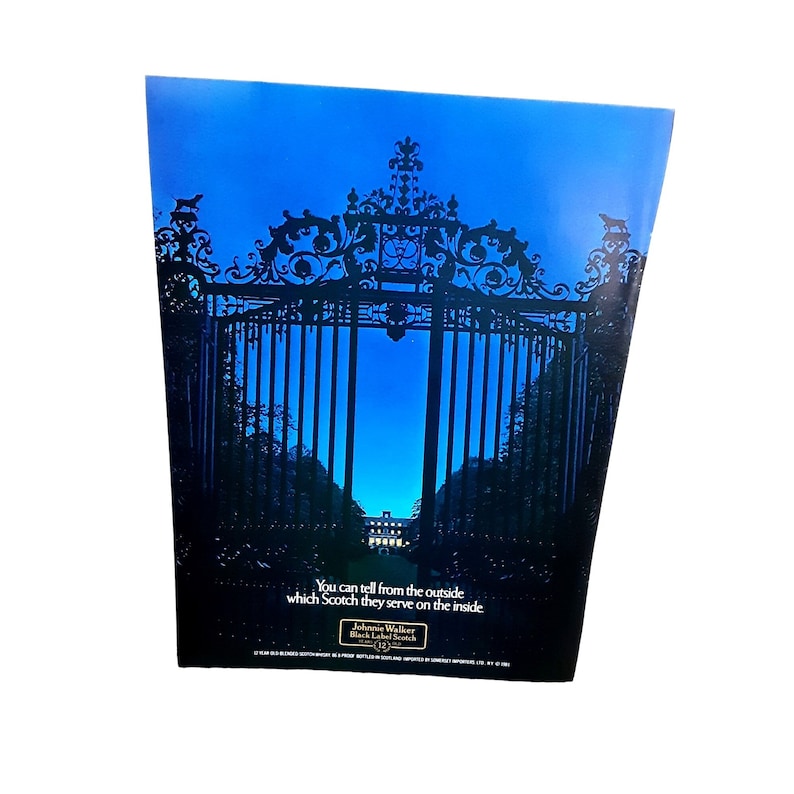 May include: A vintage advertisement for Johnnie Walker Black Label Scotch whisky. The ad features a black iron gate with a mansion visible through the gate. The text reads "You can tell from the outside which Scotch they serve on the inside. Johnnie Walker Black Label Scotch."