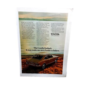 May include: A brown Toyota Corolla Fastback car is parked on a dirt road with a body of water in the background. The car has a black interior and a black bumper. The text "The Corolla Fastback. It may make our story harder to believe." is printed below the car.