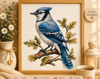 May include: A digital PDF cross stitch pattern featuring a blue jay perched on an oak branch. The text reads PREMIUM CROSS STITCH PATTERN, Digital PDF Pattern, 3 Sizes Included, Color + Symbol Charts, Beginner Friendly, Printable Pattern, KopiluwakDesign.