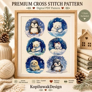 May include: A digital cross stitch pattern featuring six circular illustrations of arctic animals including penguins, a polar bear, a fox, and a seal against a starry blue background. The text reads Premium Cross Stitch Pattern, Digital PDF Pattern, and KopiluwakDesign.
