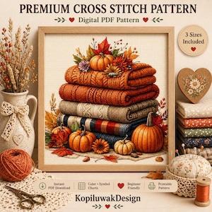 May include: A digital cross stitch pattern titled PREMIUM CROSS STITCH PATTERN featuring a stack of folded sweaters in orange, brown, and blue tones, decorated with pumpkins and autumn leaves. The design includes text indicating 3 Sizes Included and the brand name KopiluwakDesign.