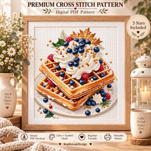 Puede incluir: Un patrón de punto de cruz enmarcado titulado Premium Cross Stitch Pattern Digital PDF Pattern que muestra una pila de gofres dorados con nata montada, arándanos, frambuesas y una hoja de arce, con texto que indica 3 tamaños incluidos.