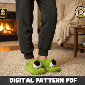 May include: Green crochet monster slippers with large, white and purple eyes. The slippers are worn with gray sweatpants. The image includes the text "DIGITAL PATTERN PDF" and a logo that says "Cazzy Crafts".
