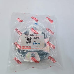 May include: A new Daihatsu joint flexible part, model 45232-87602, is sealed in a clear plastic bag. The bag has red and white Daihatsu Genuine Parts logos. The part is black and silver.
