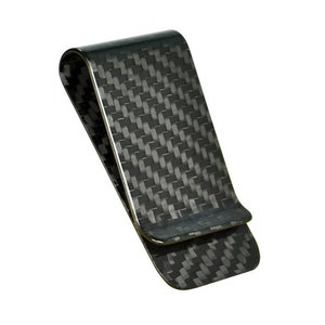 May include: A carbon fiber money clip with a woven pattern. The clip is a dark gray color and has a curved top. The money clip is designed to hold cash and cards.