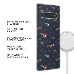May include: A navy blue phone case with a repeating pattern of horses, horseshoes, and floral elements in shades of brown, white, and red. The case is shown with a wireless charger. The text on the side says: Supports Wireless Charging, Sides Are Not Printed, Screen and Camera Bumper Raised, Full Access to Device Ports, Light Weight Soft and Flexible.