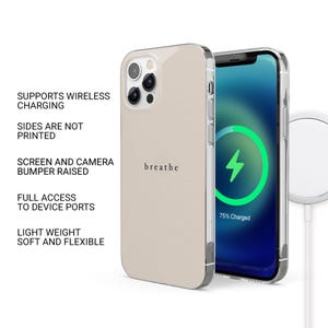 May include: A beige phone case with the word "breathe" printed on it, next to a phone displaying a charging screen. The case has a clear bumper and supports wireless charging. The phone is 75% charged.