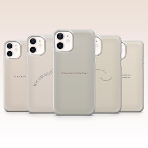 May include: A collection of five phone cases with inspirational quotes in a neutral color palette. The cases feature phrases like "breath", "YOU CAN AND YO", and "Nothing changes if nothing changes". Each case has a clear, protective cover.